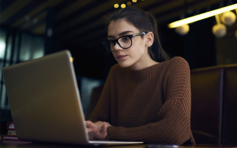 Woman working on laptop remote